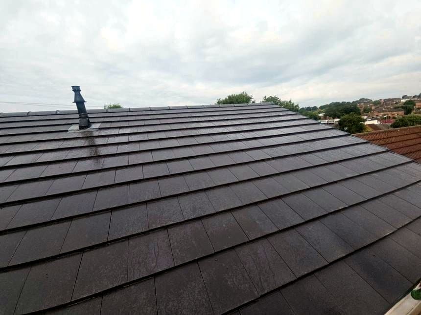 The same roof finished in new grey tile