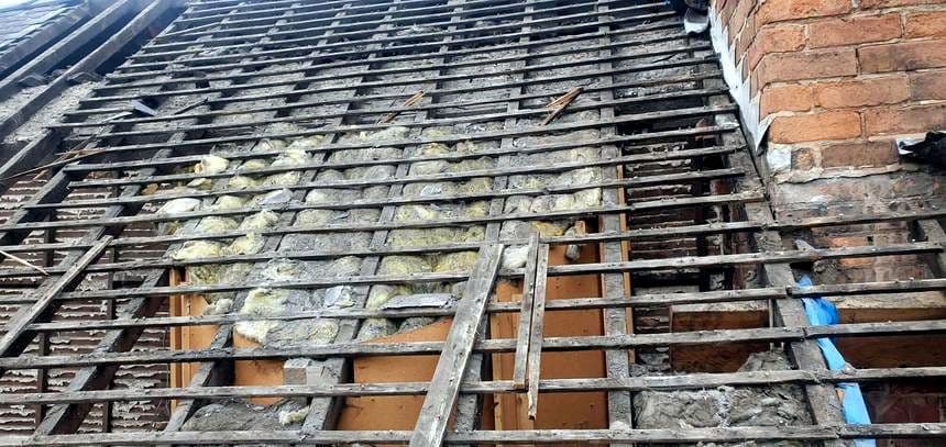 Old rotten roof timbers exposed during a strip