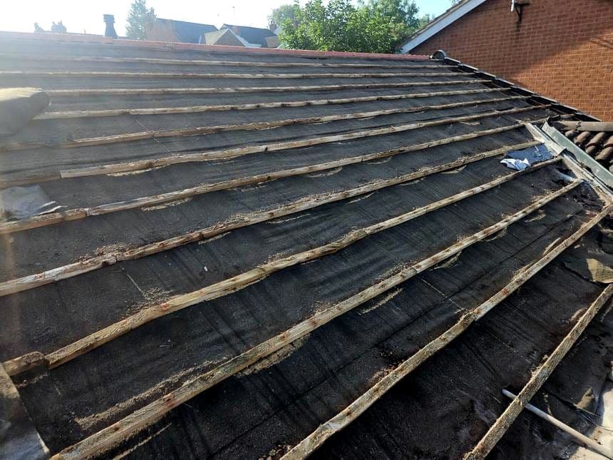 A roof stripped back to bare battens