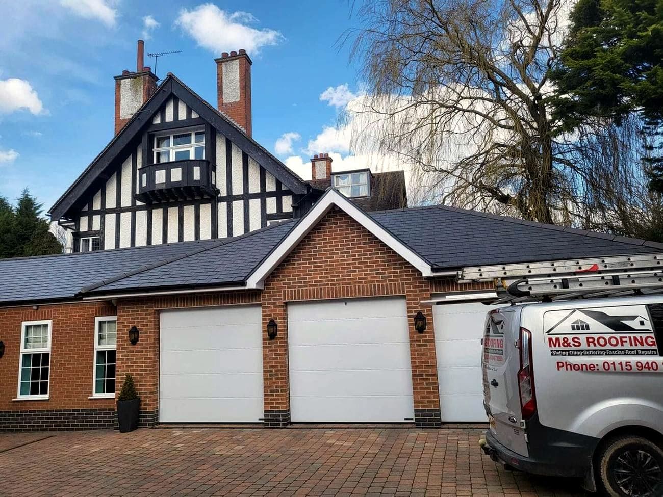 A Nottingham house with a newly laid slate roof and an M&S Roofing van on the drive